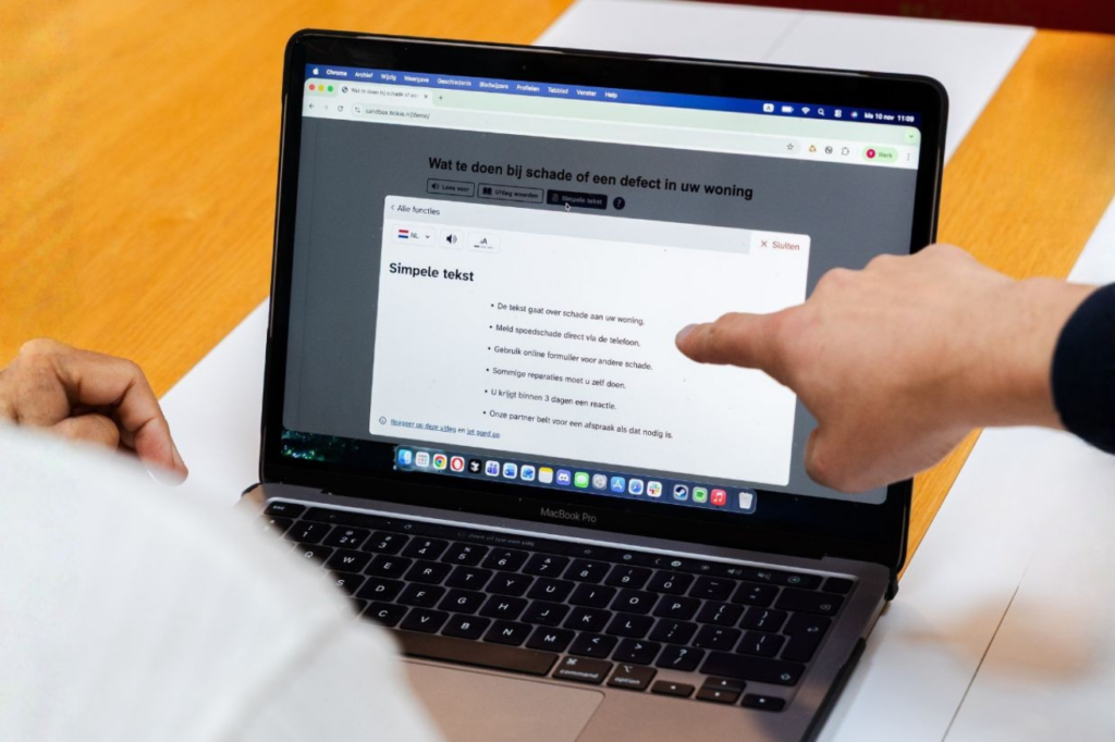 Laptop met een simpele tekst van Tolkie. Iemand wijst de simpele tekst aan.